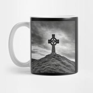 Ancient Stone Celtic Cross on a hill with the Sun shining through the cross in black and white. Mug